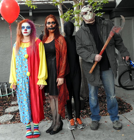 People posing in Halloween costumes